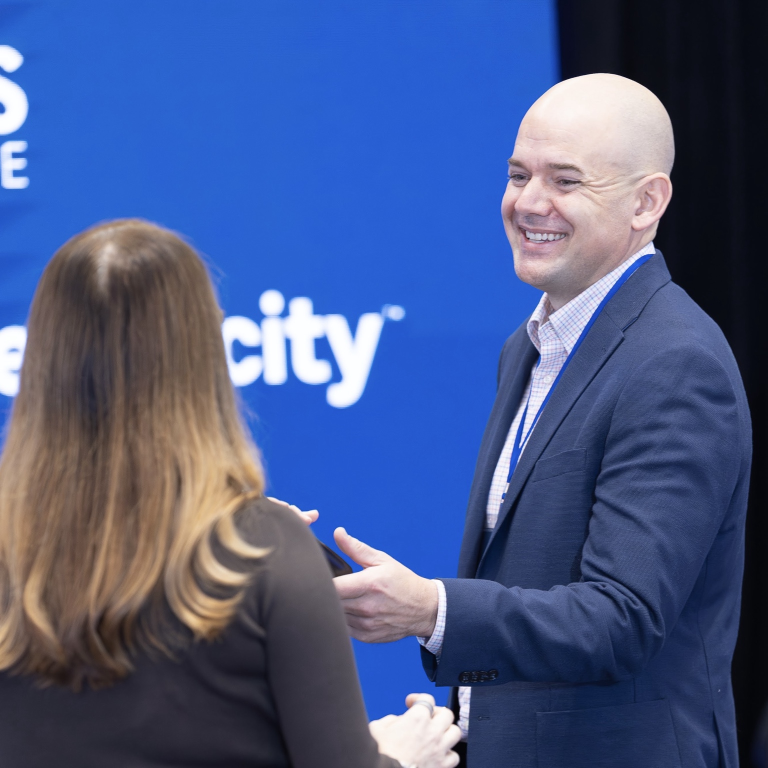 Dan Oltersdorf in conversation with a colleague