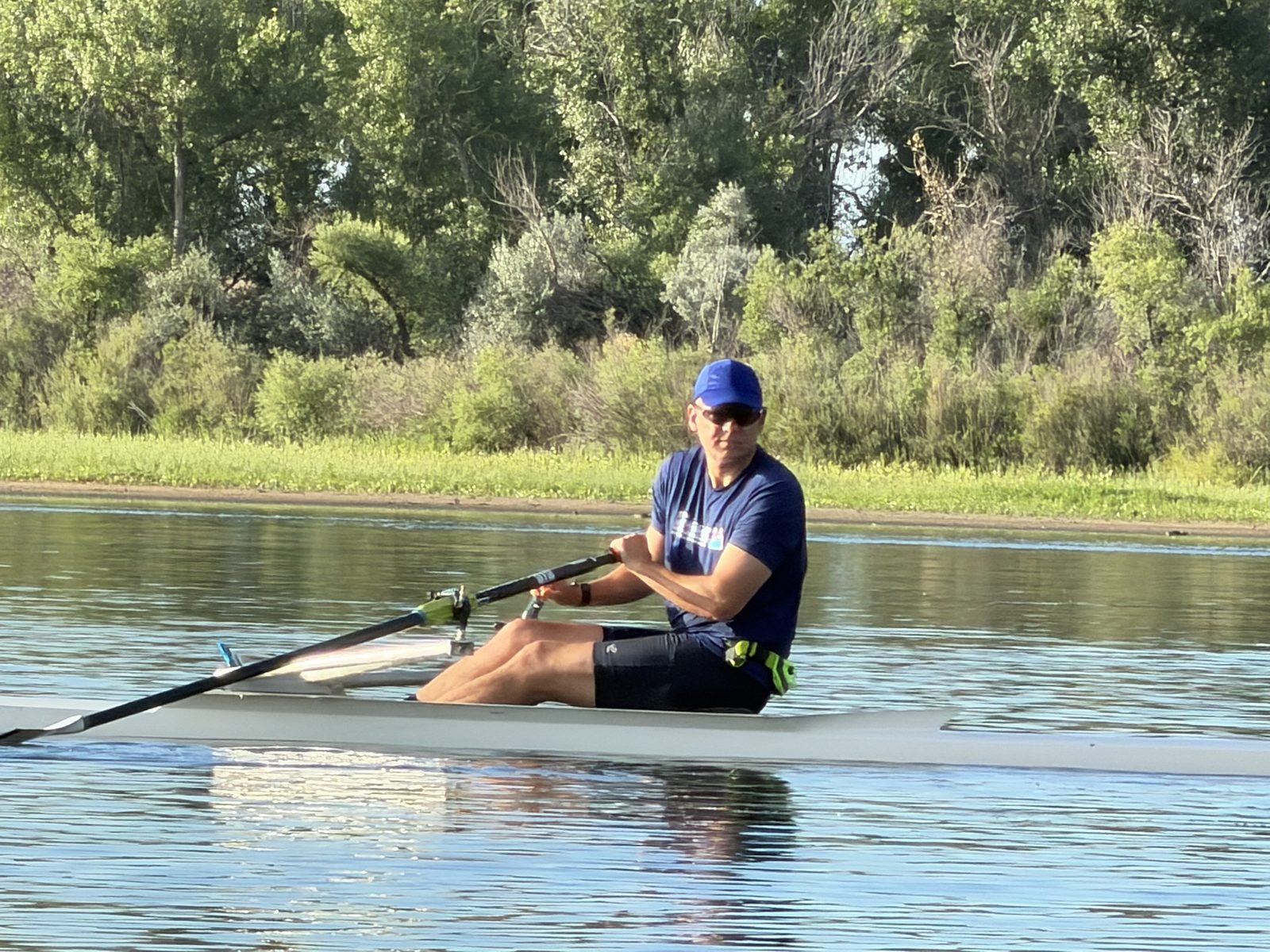 Dan rowing a single scull on a Colorado reservoir